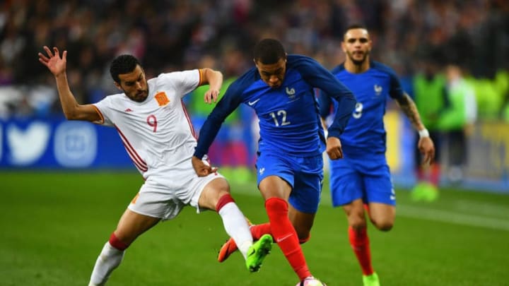 PARIS, FRANCE - MARCH 28: Kylian Mbappe of France is tackled by Pedro of Spain during the International Friendly match between France and Spain at Stade de France on March 28, 2017 in Paris, France. (Photo by Dan Mullan/Getty Images)