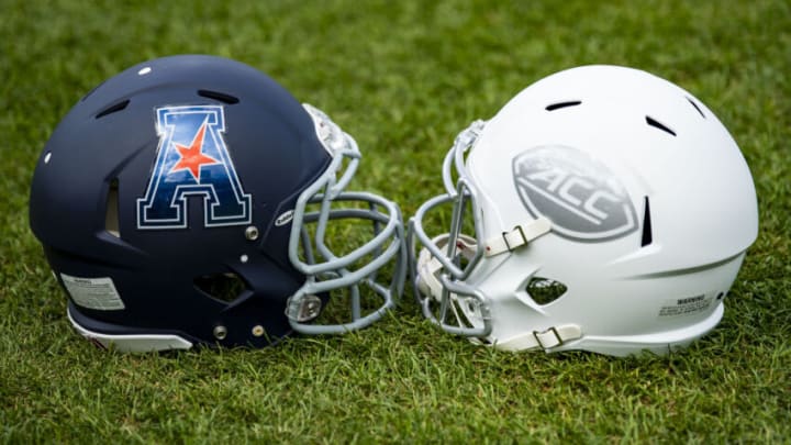 AAC and ACC helmets displayed during a press conference announcing the Fenway Bowl. Getty Images.