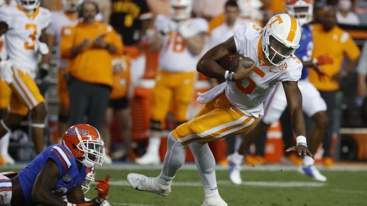 Sep 25, 2021; Gainesville, Florida, USA; Florida Gators safety Trey Dean III (0) tackles Tennessee Volunteers quarterback Hendon Hooker (5) during the first quarter at Ben Hill Griffin Stadium. Mandatory Credit: Kim Klement-USA TODAY Sports