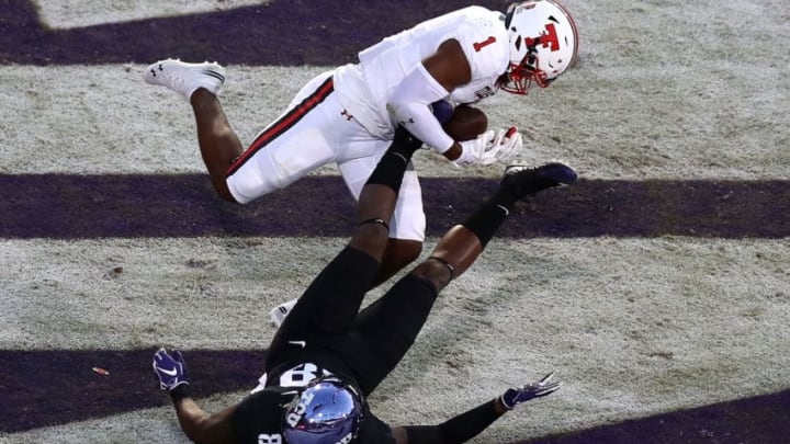 FORT WORTH, TX - OCTOBER 11: Jordyn Brooks #1 of the Texas Tech Red Raiders makes a pass interception against Artayvious Lynn #88 of the TCU Horned Frogs at Amon G. Carter Stadium on October 11, 2018 in Fort Worth, Texas. (Photo by Ronald Martinez/Getty Images)