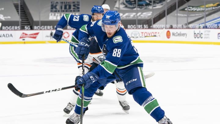 VANCOUVER, BC – MARCH 13: Nate Schmidt #88 of the Vancouver Canucks skates with the puck during NHL action against the Edmonton Oilers at Rogers Arena on March 13, 2021 in Vancouver, Canada. (Photo by Rich Lam/Getty Images)