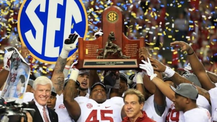 Dec 6, 2014; Atlanta, GA, USA; Alabama Crimson Tide head coach Nick Saban and his team celebrate with the trophy after the 2014 SEC Championship Game against the Missouri Tigers at the Georgia Dome. Alabama defeated Missouri 42-13. Mandatory Credit: Kevin Liles-USA TODAY Sports