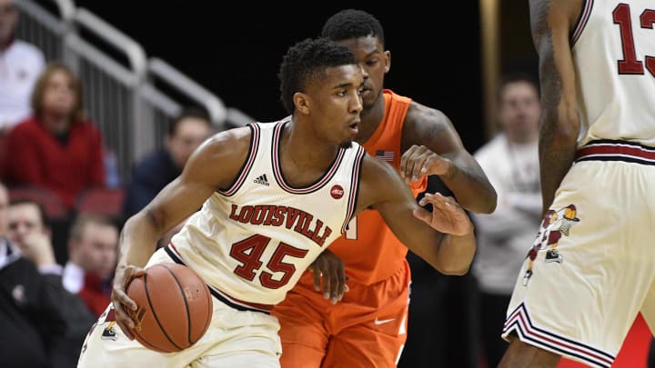 Feb 26, 2017; Louisville, KY, USA; Louisville Cardinals guard Donovan Mitchell (45) dribbles against Syracuse Orange guard Frank Howard (1) during the first half at KFC Yum! Center. Mandatory Credit: Jamie Rhodes-USA TODAY Sports