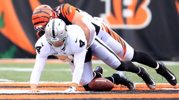 CINCINNATI, OH – DECEMBER 16: Derek Carr #4 of the Oakland Raiders fumbles the ball as he is sacked by Sam Hubbard #94 of the Cincinnati Bengals at Paul Brown Stadium on December 16, 2018 in Cincinnati, Ohio. (Photo by Andy Lyons/Getty Images)