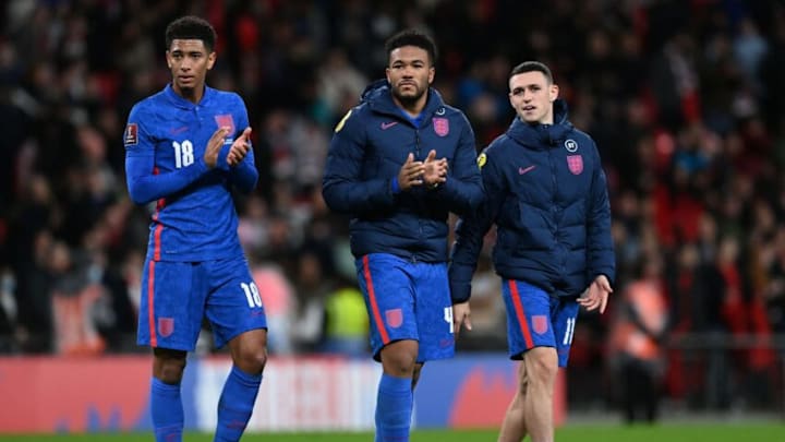 England's midfielder Jude Bellingham (L), England's defender Reece James (C) and Englands's midfielder Phil Foden (R) applaud supporters after the FIFA World Cup 2022 Group I qualifier football match between England and Albania at Wembley Stadium in London on November 12, 2021. - England won the game 5-0. - NOT FOR MARKETING OR ADVERTISING USE / RESTRICTED TO EDITORIAL USE (Photo by Glyn KIRK / AFP) / NOT FOR MARKETING OR ADVERTISING USE / RESTRICTED TO EDITORIAL USE (Photo by GLYN KIRK/AFP via Getty Images)