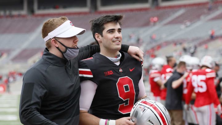 Team Buckeye quarterback Jack Miller III (9) walks off the field with quality control coach Keenan Bailey during the Ohio State Buckeyes football spring game at Ohio Stadium in Columbus on Saturday, April 17, 2021.Ohio State Football Spring Game