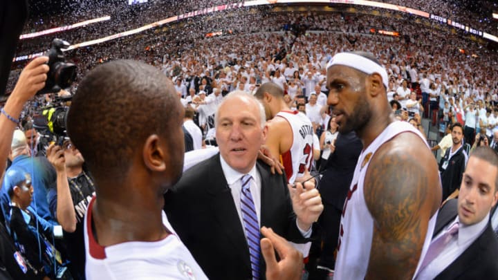 Gregg Popovich of the San Antonio Spurs congratulates Dwyane Wade (3) and LeBron James (6) of the Miami Heat after Game Seven of the 2013 NBA Finals (Photo by Jesse D. Garrabrant/NBAE via Getty Images)