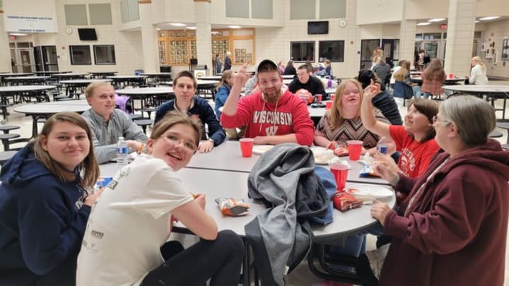Students from Reedsburg having lunch, including Annie Zekas. Photo Credit: Special Olympics