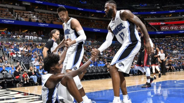 ORLANDO, FL - OCTOBER 7: Nikola Vucevic #9 and Jonathon Simmons #17 help up teammate Jonathan Isaac #1 of the Orlando Magic during a preseason against the Miami Heat game on October 8, 2017 at Amway Center in Orlando, Florida. NOTE TO USER: User expressly acknowledges and agrees that, by downloading and or using this photograph, User is consenting to the terms and conditions of the Getty Images License Agreement. Mandatory Copyright Notice: Copyright 2017 NBAE (Photo by Fernando Medina/NBAE via Getty Images)