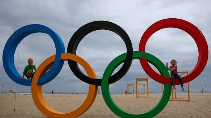 RIO DE JANEIRO, BRAZIL - JULY 21: Children pose with the Olympic Rings after its inauguration ceremony at the Copacabana Beach ahead 2016 Rio Olympics on July 21, 2016 in Rio de Janeiro, Brazil. (Photo by Buda Mendes/Getty Images)