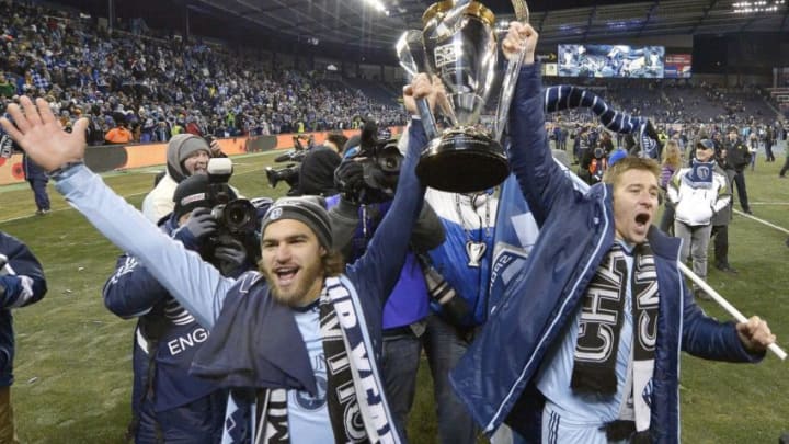 Sporting KC's Graham Zusi and Matt Besler, right, celebrate with the MLS Cup after defeating Real Salt Lake in the MLS Cup Final at Sporting Park in Kansas City, Kan., Saturday, Dec. 7, 2013. Kansas City won on penalty kicks. (John Sleezer/Kansas City Star/Tribune News Service via Getty Images)