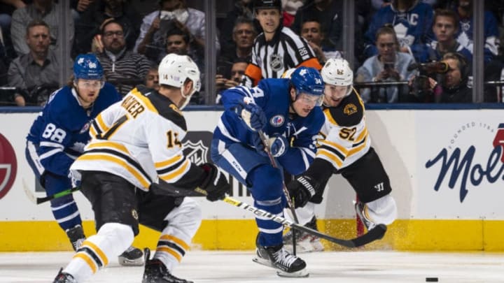 TORONTO, ON - NOVEMBER 15: Auston Matthews #34 of the Toronto Maple Leafs battles for the puck against Sean Kuraly #52 of the Boston Bruins during the second period at the Scotiabank Arena on November 15, 2019 in Toronto, Ontario, Canada. (Photo by Mark Blinch/NHLI via Getty Images)
