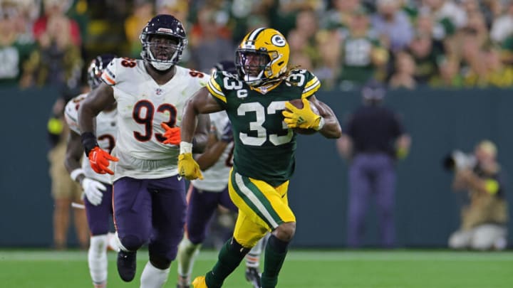 GREEN BAY, WISCONSIN - SEPTEMBER 18: Aaron Jones #33 of the Green Bay Packers runs for yards during a game against the Chicago Bears at Lambeau Field on September 18, 2022 in Green Bay, Wisconsin. The Packers defeated the Bears 27-10. (Photo by Stacy Revere/Getty Images)