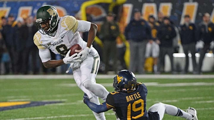 MORGANTOWN, WV - DECEMBER 03: Ishmael Zamora #8 of the Baylor Bears is wrapped up after a catch by Elijah Battle #19 of the West Virginia Mountaineers in the second half during the game at Mountaineer Field on December 3, 2016 in Morgantown, West Virginia. (Photo by Justin Berl/Getty Images)