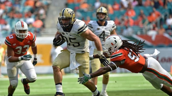 Nov 5, 2016; Miami Gardens, FL, USA; Pittsburgh Panthers fullback George Aston (35) runs past Miami Hurricanes linebacker Mike Smith (57) during the first half at Hard Rock Stadium. Mandatory Credit: Steve Mitchell-USA TODAY Sports