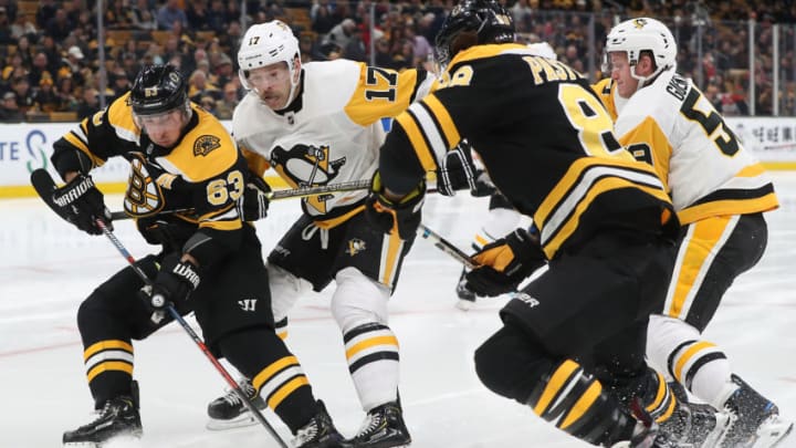 BOSTON - NOVEMBER 23: Boston Bruins left wing Brad Marchand (63) controls the puck in front of Pittsburgh Penguins right wing Bryan Rust (17) during the third period. The Boston Bruins host the Pittsburgh Penguins in a regular season NHL hockey game at TD Garden in Boston on Nov. 23, 2018. (Photo by Matthew J. Lee/The Boston Globe via Getty Images)
