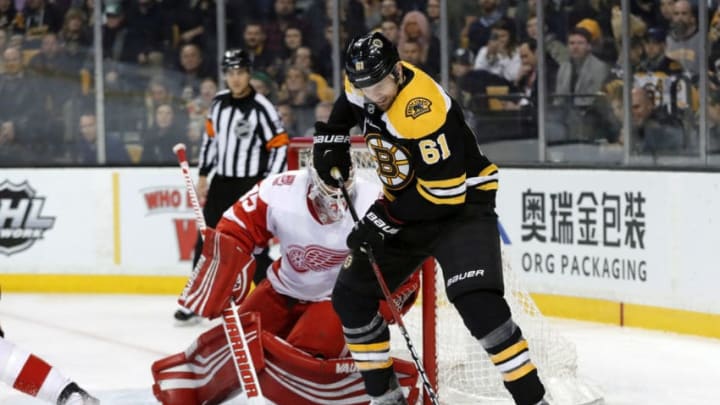 BOSTON, MA - MARCH 06: Boston Bruins right wing Rick Nash (61) holds the puck in front of Detroit Red Wings goalie Jimmy Howard (35) during a game between the Boston Bruins and the Detroit Red Wings on March 6, 2018, at TD Garden in Boston, Massachusetts. The Bruins defeated the Red Wings 6-5 (OT). (Photo by Fred Kfoury III/Icon Sportswire via Getty Images)