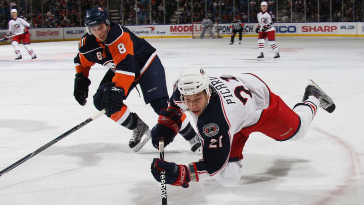 UNIONDALE, NY – DECEMBER 29: Alexandre Picard #21 of the Columbus Blue Jackets trips with the puck as he carries against Bruno Gervais #8 of the New York Islanders at the Nassau Coliseum on December 29, 2009 in Uniondale, New York. (Photo by Bruce Bennett/Getty Images)