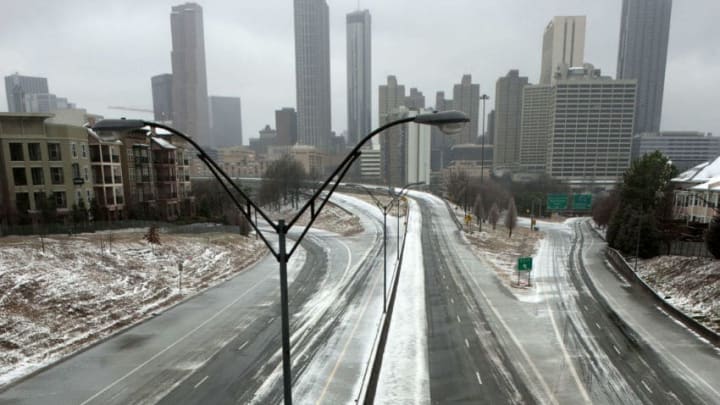 ATLANTA, GA - FEBRUARY 12: A normally busy Freedom Parkway sits empty in front of the Atlanta skyline on February 12, 2014 in Atlanta, Georgia. Public schools were closed for another day, and hazardous road conditions kept most people home. A state of emergency was declared in 45 Georgia counties as sleet, freezing rain and snow fell across the state. (Photo by Davis Turner/Getty Images)