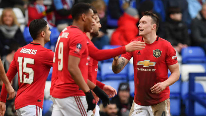 Manchester United's English defender Phil Jones (R) celebrates with teammates after scoring their fourth goal during the English FA Cup fourth round football match between Tranmere Rovers and Manchester United at Prenton Park in Birkenhead, north west England, on January 26, 2020. (Photo by Paul ELLIS / AFP) / RESTRICTED TO EDITORIAL USE. No use with unauthorized audio, video, data, fixture lists, club/league logos or 'live' services. Online in-match use limited to 120 images. An additional 40 images may be used in extra time. No video emulation. Social media in-match use limited to 120 images. An additional 40 images may be used in extra time. No use in betting publications, games or single club/league/player publications. / (Photo by PAUL ELLIS/AFP via Getty Images)