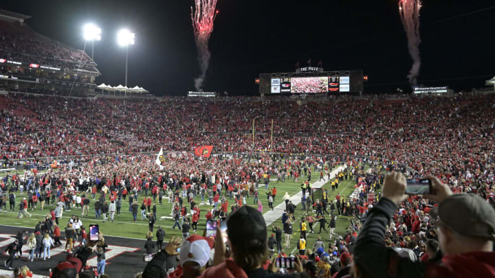 Oct 7, 2023; Louisville, Kentucky, USA; Louisville Cardinals fans flood the field in celebration after time expired against the Notre Dame Fighting Irish at L&N Federal Credit Union Stadium. Louisville defeated Notre Dame 33-20. Mandatory Credit: Jamie Rhodes-USA TODAY Sports