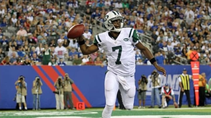 Aug 24, 2013; East Rutherford, NJ, USA; New York Jets quarterback Geno Smith (7) steps out of bounds to avoid a safety in the fourth quarter against the New York Giants at MetLife Stadium. Mandatory Credit: John Munson/The Star-Ledger via USA TODAY Sports