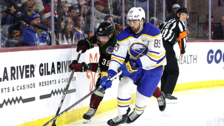 TEMPE, ARIZONA - DECEMBER 16: Alex Tuch #89 of the Buffalo Sabres skates with the puck against Liam O'Brien #38 of the Arizona Coyotes during the second period at Mullett Arena on December 16, 2023 in Tempe, Arizona. (Photo by Zac BonDurant/Getty Images)