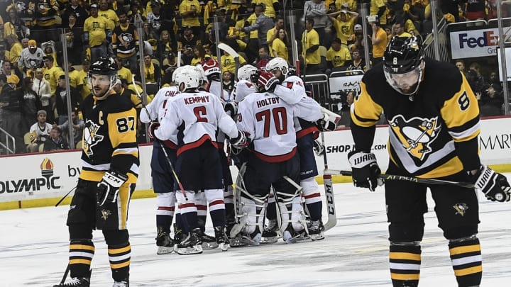 Sidney Crosby, left, skates away as the Washington Capitals celebrate after wining Game 6 of the Second Round of the Stanley Cup Playoffs between the Washington Capitals and the Pittsburgh Penguins at PPG Paints Arena on Monday, May 7, 2018. The Washington Capitals won 2-1 to advance the next round. (Photo by Toni L. Sandys/The Washington Post via Getty Images)