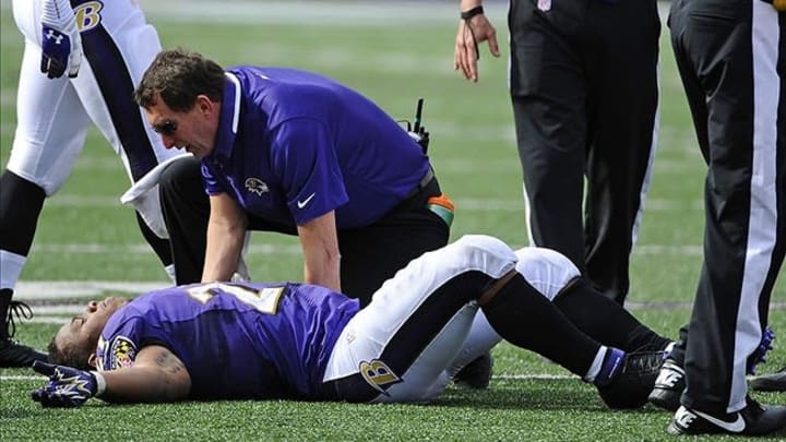 Sep 15, 2013; Baltimore, MD, USA; Baltimore Ravens running back Ray Rice (27) is looked at by a team trainer after suffering an apparent hip injury against the Cleveland Browns during the second half at M