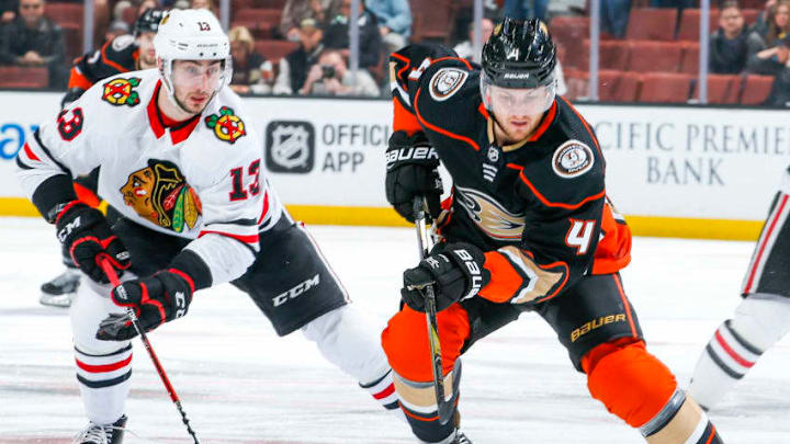 ANAHEIM, CA - MARCH 4: Cam Fowler #4 of the Anaheim Ducks handles the puck with pressure from Tomas Jurco #13 of the Chicago Blackhawks during the first period of the game at Honda Center on March 4, 2018 in Anaheim, California. (Photo by Debora Robinson/NHLI via Getty Images) *** Local Caption ***