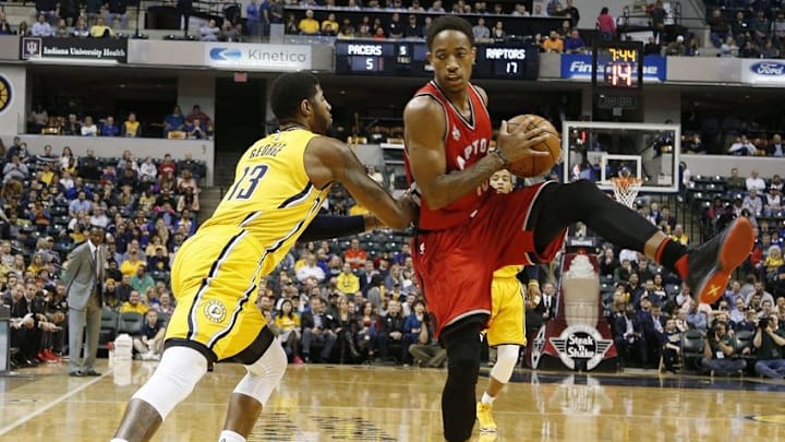 Dec 14, 2015; Indianapolis, IN, USA; Indiana Pacers forward Paul George (13) guards Toronto Raptors guard DeMar DeRozan (10) at Bankers Life Fieldhouse. Indiana defeats Toronto 106-90. Mandatory Credit: Brian Spurlock-USA TODAY Sports