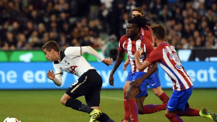 Tottenham Hotspur player Harry Winks (L) fights for the ball with Atletico Madrid's Atletico Madrid's midfielder Thomas Partey (C) during the International Champions Cup football match between English Premier League team Tottenham Hotspur and Spanish club Atletico Madrid in Melbourne on July 29, 2016. / AFP / SAEED KHAN (Photo credit should read SAEED KHAN/AFP/Getty Images)