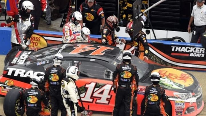 May 1, 2016; Talladega, AL, USA; NASCAR Sprint Cup Series driver Tony Stewart (left) and Ty Dillon (right) exchange places as driver in a pit stop during the GEICO 500 at Talladega Superspeedway. Mandatory Credit: John David Mercer-USA TODAY Sports