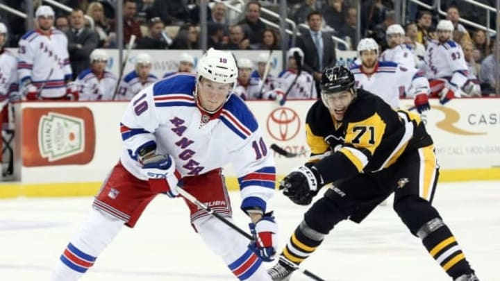 Mar 3, 2016; Pittsburgh, PA, USA; New York Rangers center J.T. Miller (10) carries the puck against pressure from Pittsburgh Penguins center Evgeni Malkin (71) during the first period at the CONSOL Energy Center. Mandatory Credit: Charles LeClaire-USA TODAY Sports