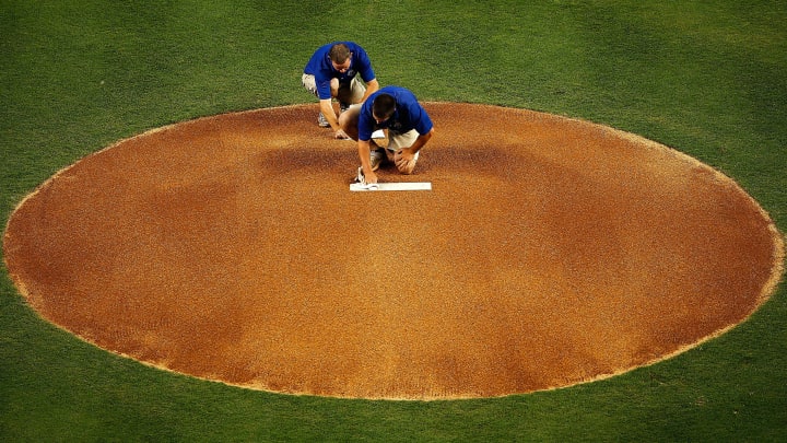 MIAMI, FL – APRIL 01: Members of the grounds crew clean the pitcher’s rubber before a game between the Miami Marlins and the New York Yankees at Marlins Park on April 1, 2012 in Miami, Florida. (Photo by Mike Ehrmann/Getty Images)