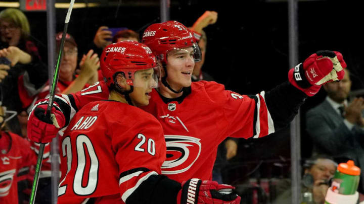 RALEIGH, NC - OCTOBER 26: Andrei Svechnikov #37 of the Carolina Hurricanes celebrates with teammate Sebastian Aho #20 after scoring a goal during an NHL game against the Chicago Blackhawks on October 26, 2019 at PNC Arena in Raleigh North Carolina. (Photo by Gregg Forwerck/NHLI via Getty Images)