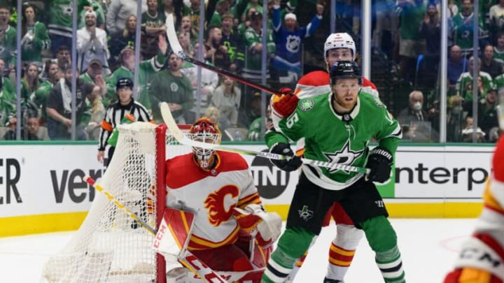 May 13, 2022; Dallas, Texas, USA; Calgary Flames goaltender Jacob Markstrom (25) and defenseman Rasmus Andersson (4) and Dallas Stars center Joe Pavelski (16) look for the puck during the third period in game six of the first round of the 2022 Stanley Cup Playoffs at American Airlines Center. Mandatory Credit: Jerome Miron-USA TODAY Sports