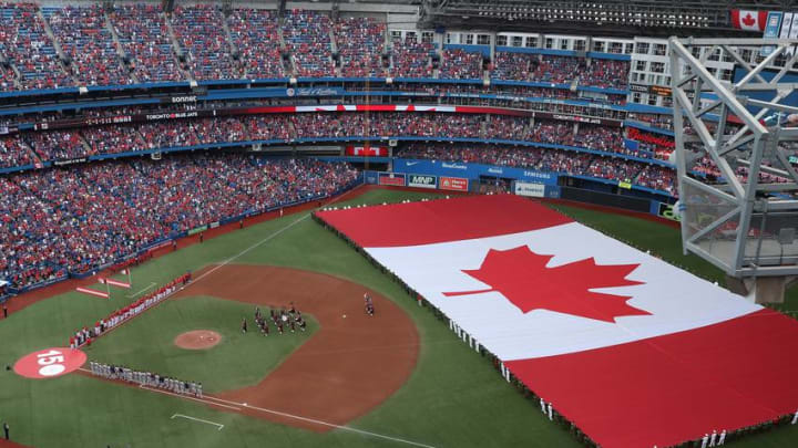 TORONTO, ON - JULY 1: A general view of Rogers Centre as a large Canadian flag is unfurled in the outfield on Canada Day during the playing of the Canadian national anthem before the start of the Toronto Blue Jays MLB game against the Boston Red Sox at Rogers Centre on July 1, 2017 in Toronto, Canada. (Photo by Tom Szczerbowski/Getty Images)