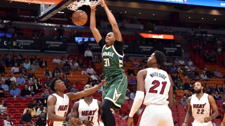 Nov 17, 2016; Miami, FL, USA; Milwaukee Bucks forward John Henson (31) dunks the ball past Miami Heat center Hassan Whiteside (21) during the first half at American Airlines Arena. Mandatory Credit: Steve Mitchell-USA TODAY Sports