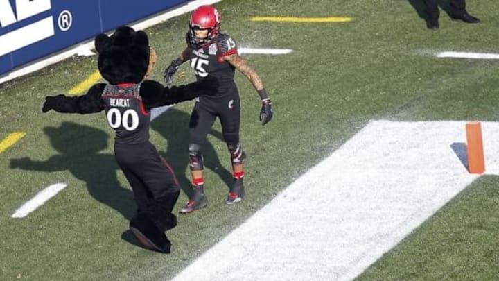 Dec 27, 2014; Annapolis, MD, USA; Cincinnati Bearcats wide receiver Chris Moore (15) celebrates with Bearcats mascot "Bearcat" after scoring a touchdown against the Virginia Tech Hokies in the first quarter of the 2014 Military Bowl at Navy-Marine Corps Memorial Stadium. Mandatory Credit: Geoff Burke-USA TODAY Sports