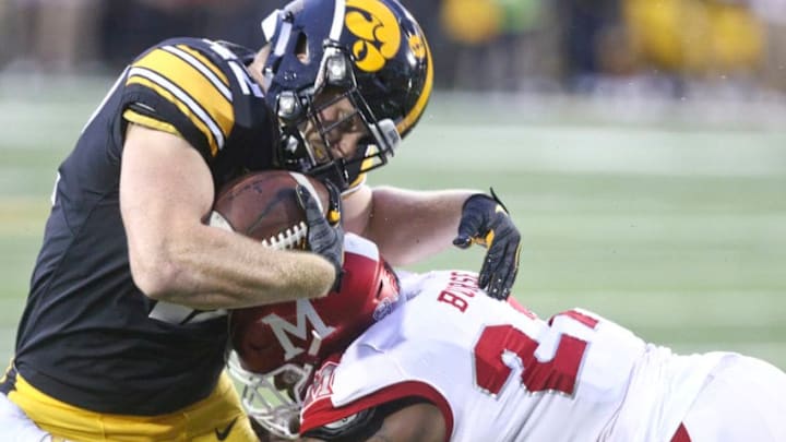 IOWA CITY, IOWA- AUGUST 31: Tight end Shaun Beyer #42 of the Iowa Hawkeyes is tackled during the first half by linebacker Kobe Burse #27 of the Miami Ohio RedHawks on August 31, 2019 at Kinnick Stadium in Iowa City, Iowa. (Photo by Matthew Holst/Getty Images)