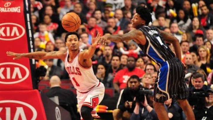Jan 12, 2015; Chicago, IL, USA; Chicago Bulls guard Derrick Rose (1) and Orlando Magic guard Elfrid Payton (4) go for a loose ball during the first half at the United Center. Mandatory Credit: David Banks-USA TODAY Sports
