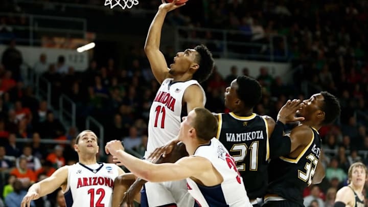 Mar 17, 2016; Providence, RI, USA; Arizona Wildcats guard Allonzo Trier (11) shoots the ball over Wichita State Shockers center Bush Wamukota (21) and forward Markis McDuffie (32) during the first half of a first round game of the 2016 NCAA Tournament at Dunkin Donuts Center. Mandatory Credit: Mark L. Baer-USA TODAY Sports