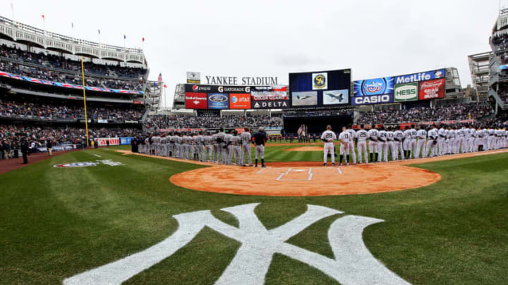 NEW YORK, NY - MARCH 31: The New York Yankees and the Detroit Tigers look on as West Point Cadets unfurl the American Flag during the opening ceremonies on Opening Day at Yankee Stadium on March 31, 2011 in Bronx borough of New York City. (Photo by Nick Laham/Getty Images)
