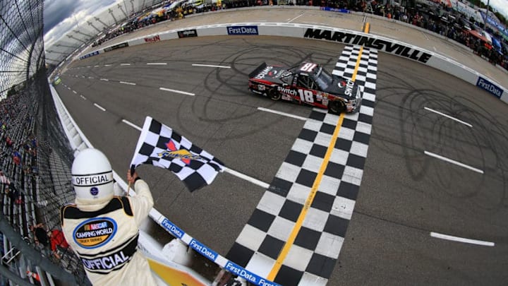 MARTINSVILLE, VA - OCTOBER 28: Noah Gragson, driver of the #18 Switch Toyota, takes the checkered flag to win the NASCAR Camping World Truck Series Texas Roadhouse 200 at Martinsville Speedway on October 28, 2017 in Martinsville, Virginia. (Photo by Chris Trotman/Getty Images)