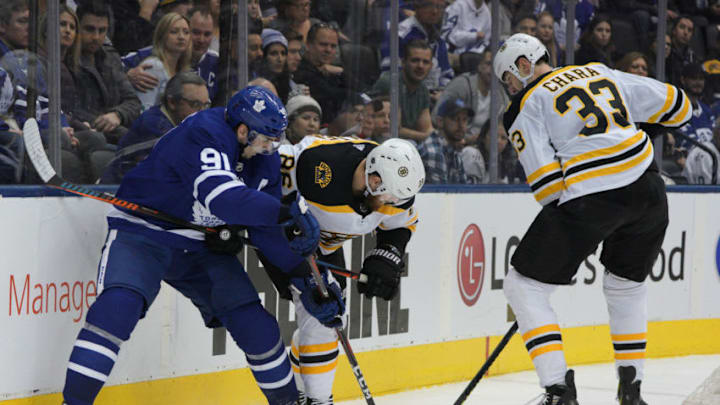 TORONTO, ON - JANUARY 12: Boston Bruins Defenceman Zdeno Chara (33) lends a hand to teammate Defenceman Kevan Miller (86) as they fend off Toronto Maple Leafs Center John Tavares (91) behind the Boston net during the regular season NHL game between the Boston Bruins and Toronto Maple Leafs on January 12, 2019 at Scotiabank Arena in Toronto, ON. (Photo by Jeff Chevrier/Icon Sportswire via Getty Images)