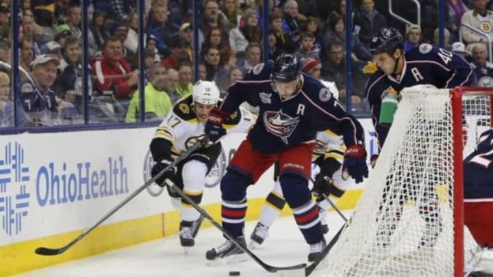 Nov 21, 2014; Columbus, OH, USA; Columbus Blue Jackets defenseman Jack Johnson (7) and Boston Bruins left wing Milan Lucic (17) battle for the loose puck during the first period at Nationwide Arena. Mandatory Credit: Russell LaBounty-USA TODAY Sports
