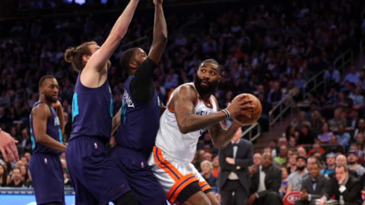 Jan 27, 2017; New York, NY, USA; New York Knicks center Kyle O'Quinn (9) controls the ball against Charlotte Hornets small forward Michael Kidd-Gilchrist (14) and Charlotte Hornets power forward Spencer Hawes (00) during the third quarter at Madison Square Garden. Mandatory Credit: Brad Penner-USA TODAY Sports