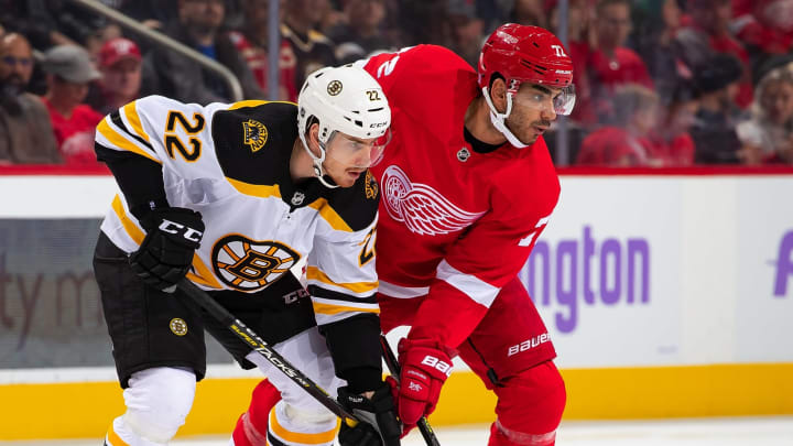DETROIT, MI - NOVEMBER 08: Peter Cehlarik #22 of the Boston Bruins battles for position with Andreas Athanasiou #72 of the Detroit Red Wings during an NHL game at Little Caesars Arena on November 8, 2019 in Detroit, Michigan. Detroit defeated Boston 4-2. (Photo by Dave Reginek/NHLI via Getty Images)