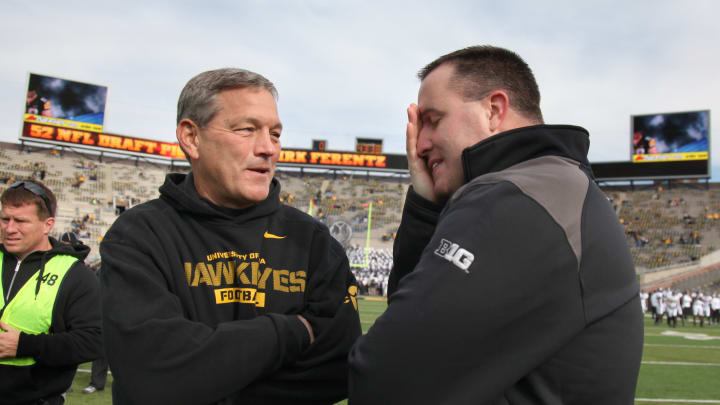 IOWA CITY, IOWA – OCTOBER 26: Head coach Kirk Ferentz of the Iowa Hawkeyes visits with head coach Pat Fitzgerald of the Northwestern Wildcats prior to their match-up on October 26, 2013 at Kinnick Stadium in Iowa City, Iowa. (Photo by Matthew Holst/Getty Images)